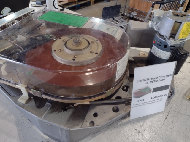 An old IBM hard drive with a whopping 13MB of storage. It looks like a giant red record in an overly complex record player.